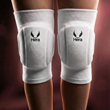 White knee pads with Hera logo on a dark background